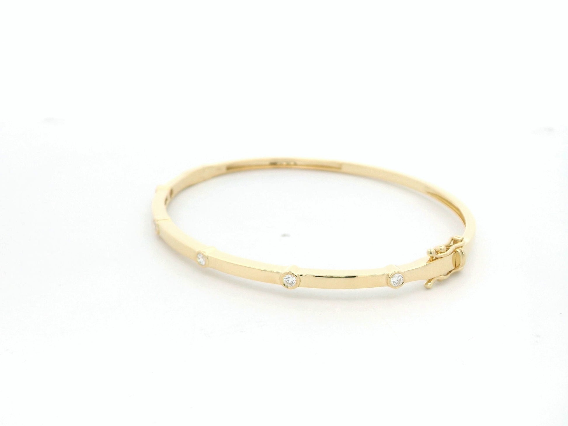 Minimal diamond bangle bracelet in 18K yellow gold with bezel-set natural diamonds