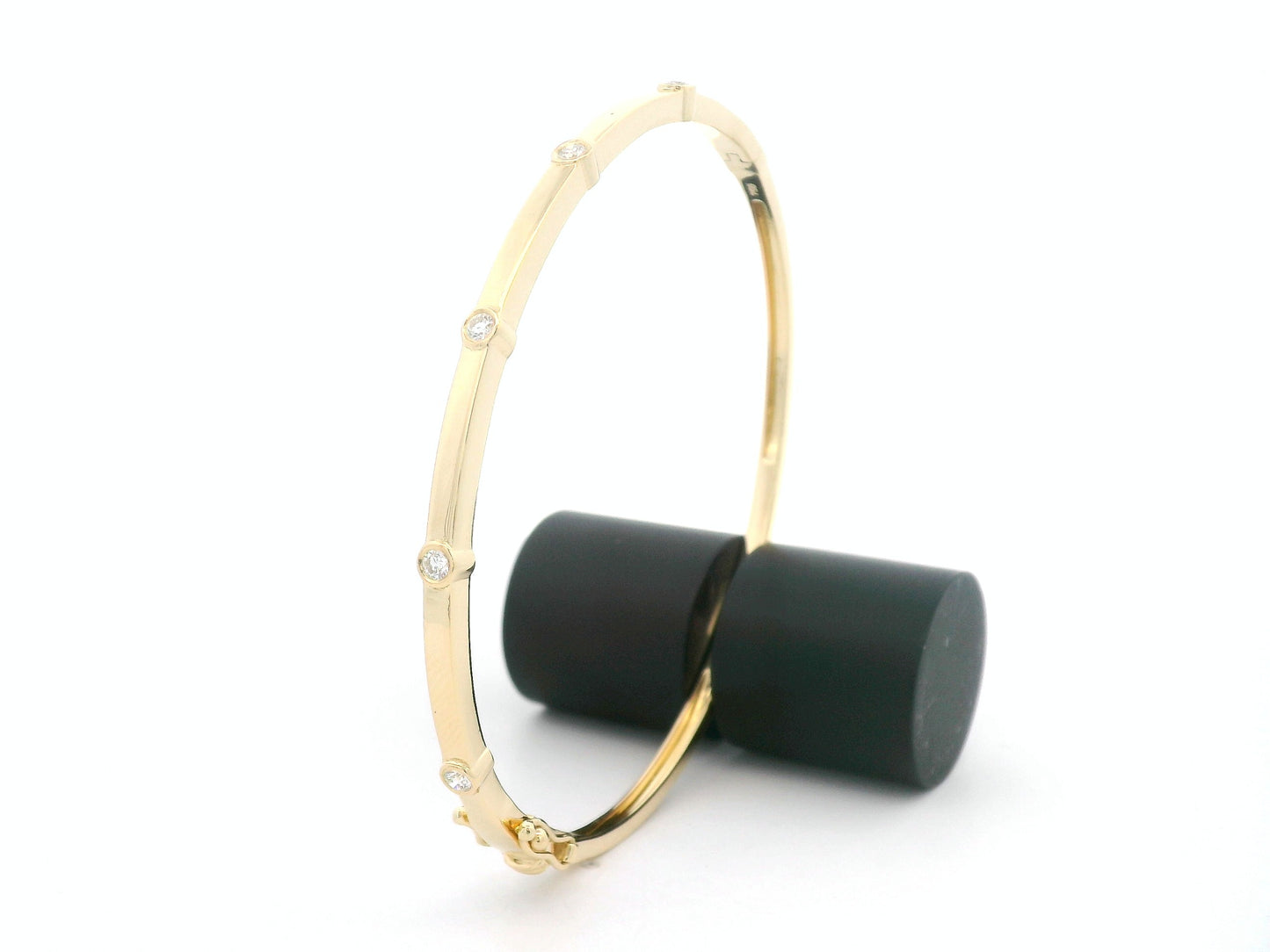 Minimal diamond bangle bracelet in 18K yellow gold with bezel-set natural diamonds