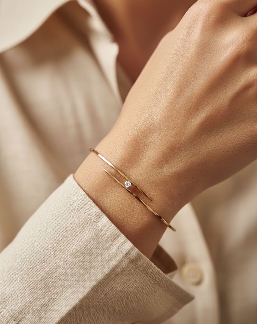 18K yellow gold rigid open bangle with tension-set 0.10 carat diamond by Emirates Diamonds