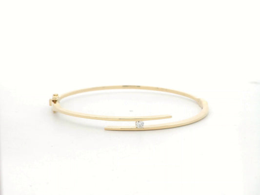 18K yellow gold rigid open bangle with tension-set 0.10 carat diamond by Emirates Diamonds