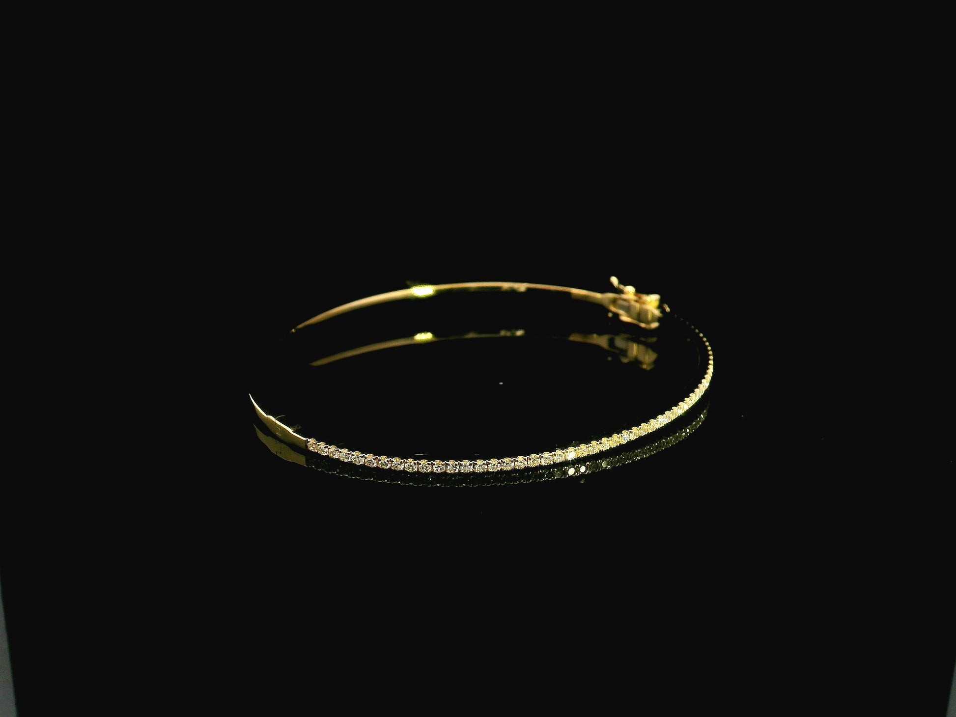 18K yellow gold diamond bangle featuring 0.54 carat natural diamonds in an elegant open bangle bracelet design.