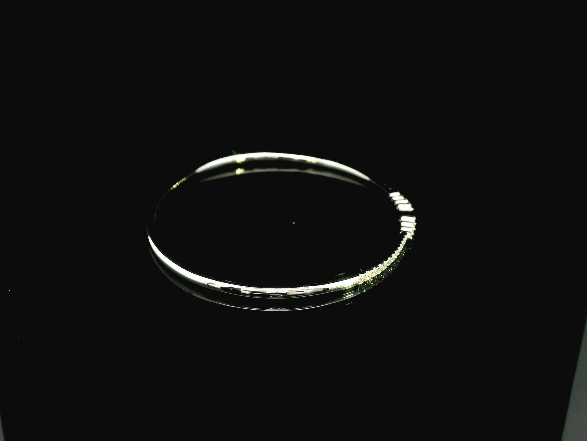 18K white gold diamond bangle featuring 0.54 carat natural diamonds in an elegant open bangle design.