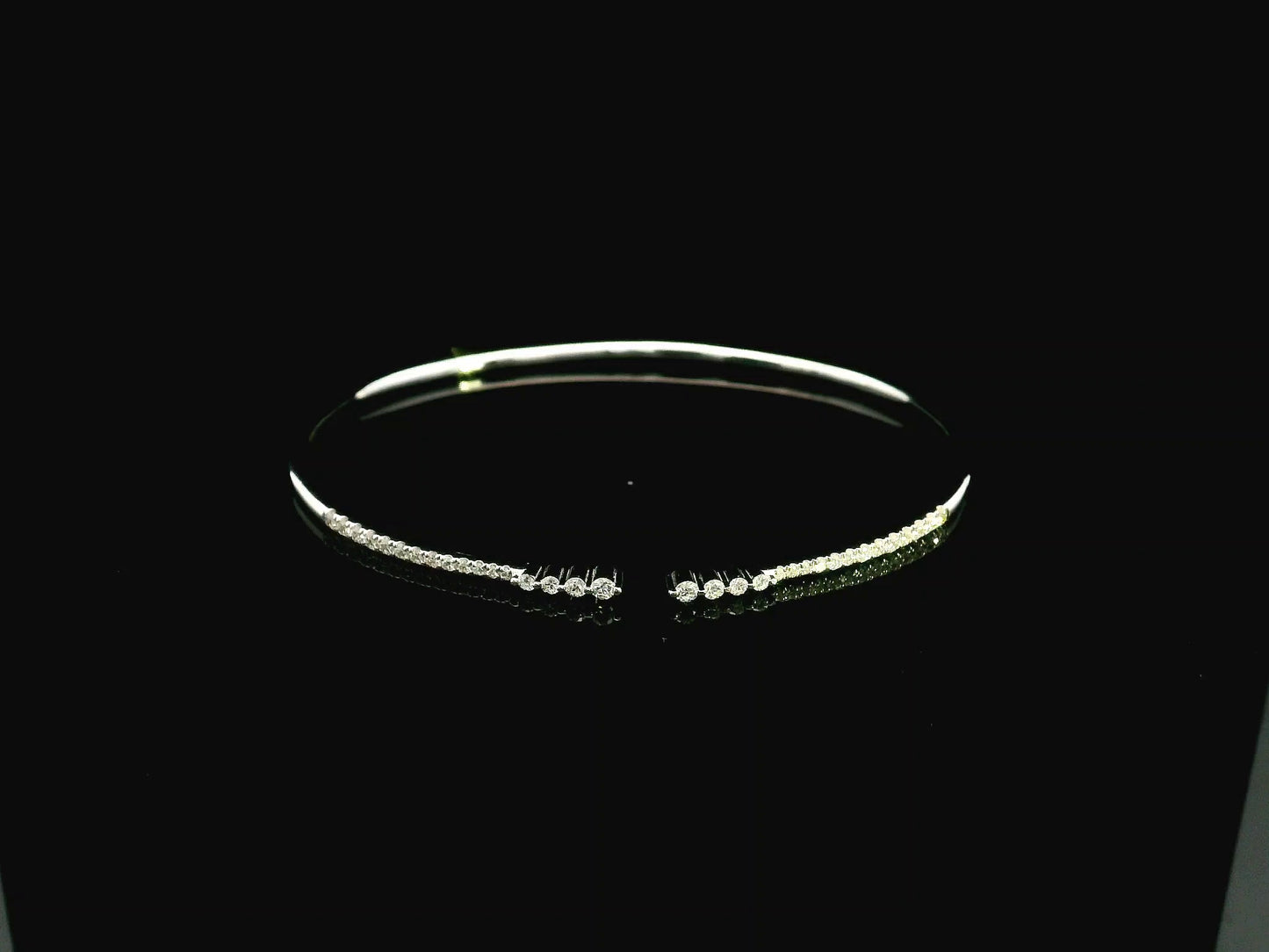 18K white gold diamond bangle featuring 0.54 carat natural diamonds in an elegant open bangle design.