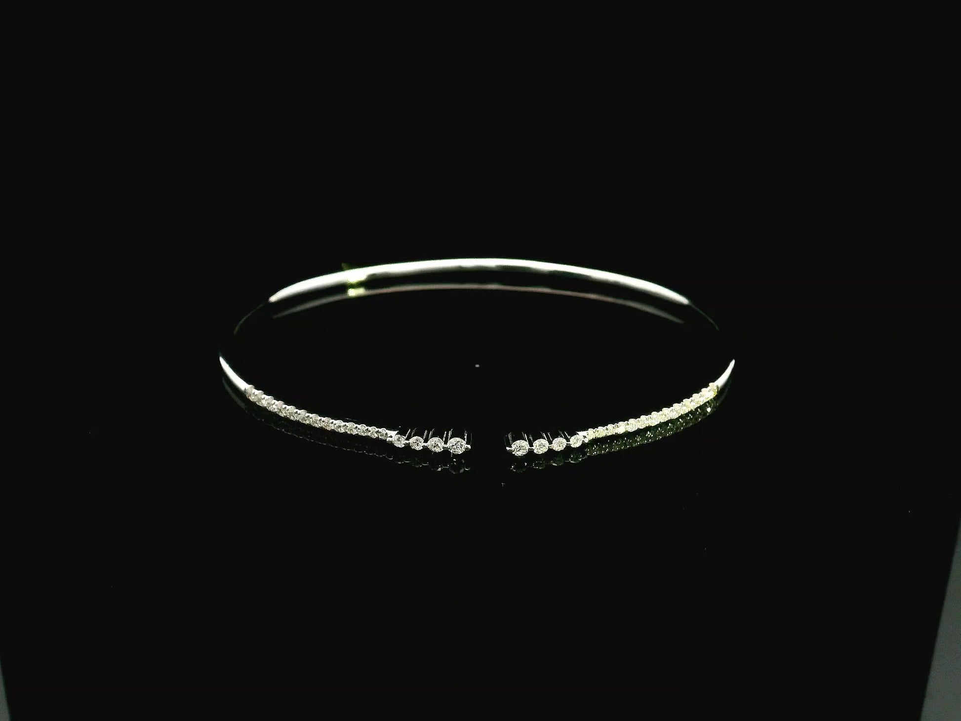 18K white gold diamond bangle featuring 0.54 carat natural diamonds in an elegant open bangle design.