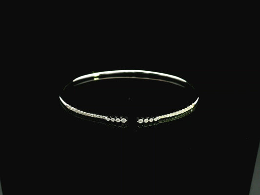 18K white gold diamond bangle featuring 0.54 carat natural diamonds in an elegant open bangle design.