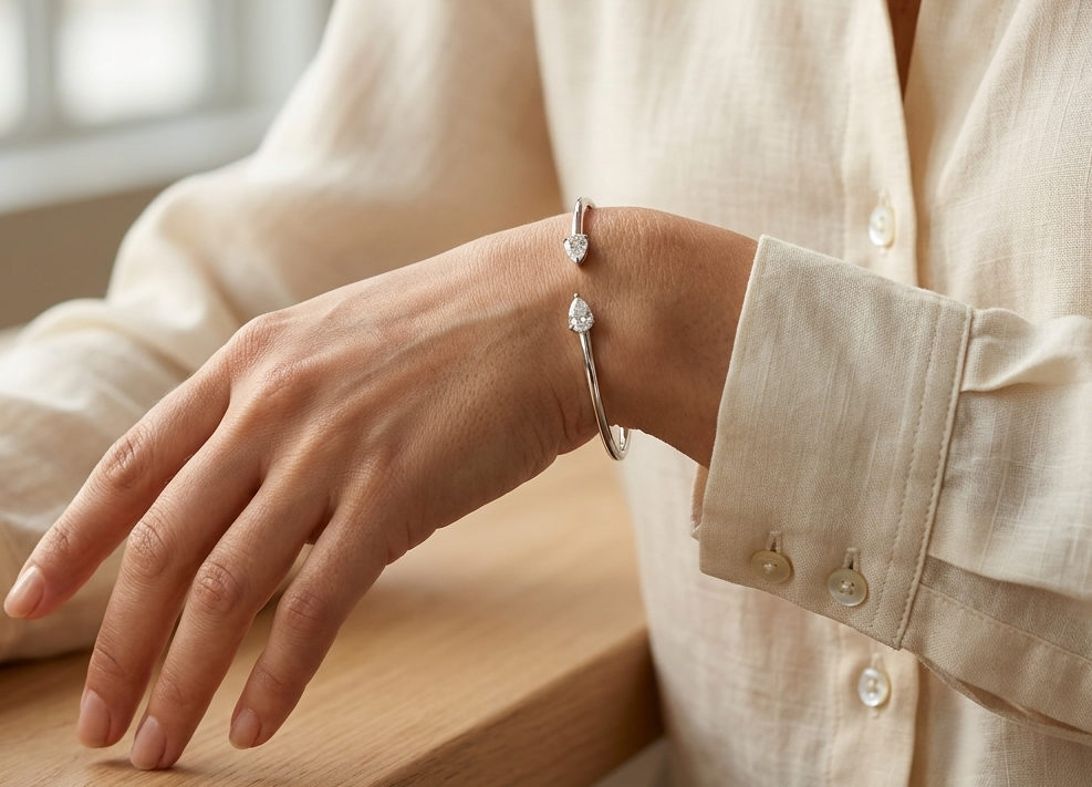 18K white gold open cuff bangle featuring pear-shaped natural diamonds with a total diamond weight of 0.61 Carat.