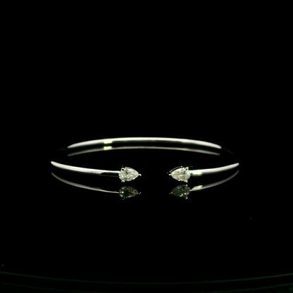18K white gold open cuff bangle featuring pear-shaped natural diamonds with a total diamond weight of 0.61 Carat.