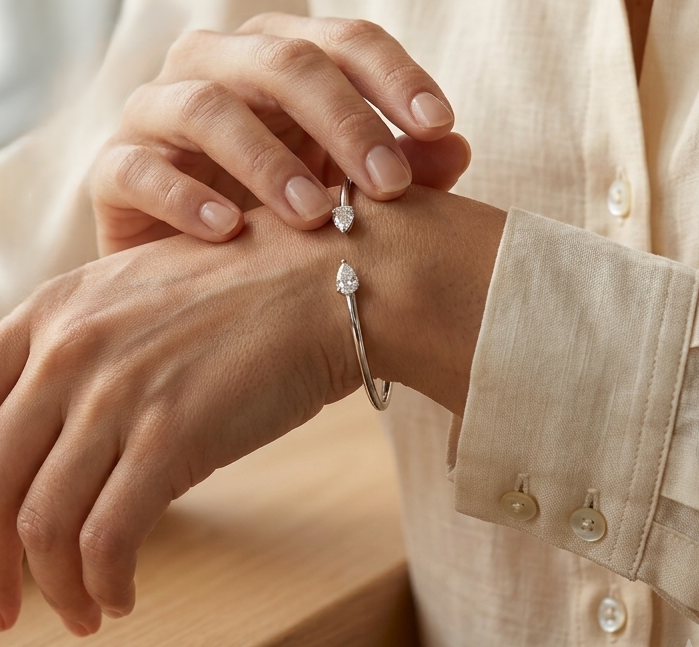 18K white gold open cuff bangle featuring pear-shaped natural diamonds with a total diamond weight of 0.61 Carat.