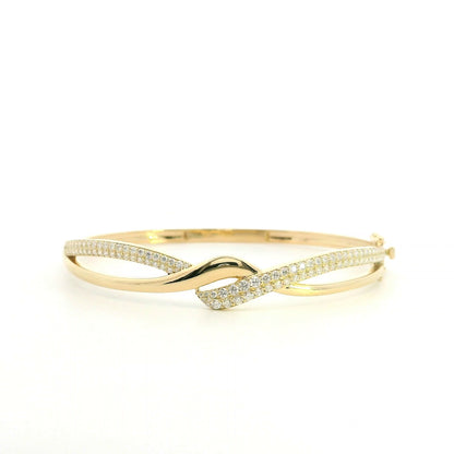 18K yellow gold diamond crossover bangle with intertwined polished and pavé diamond-set sections.