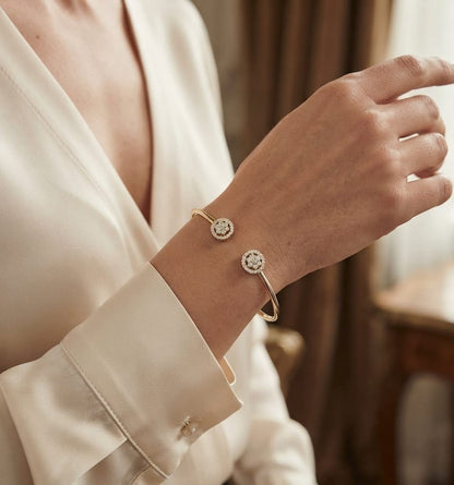 18K yellow gold open cuff bangle with two round natural diamond cluster ends.