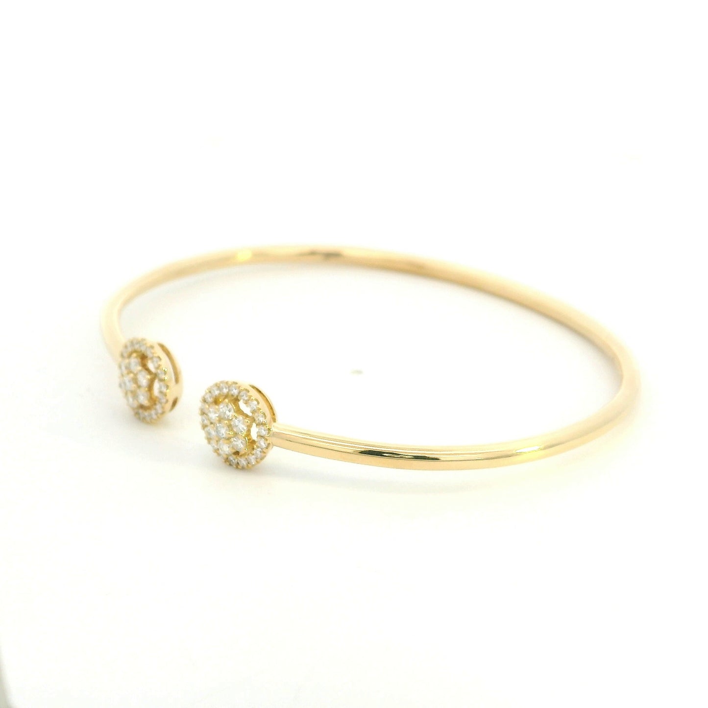 18K yellow gold open cuff bangle with two round natural diamond cluster ends.