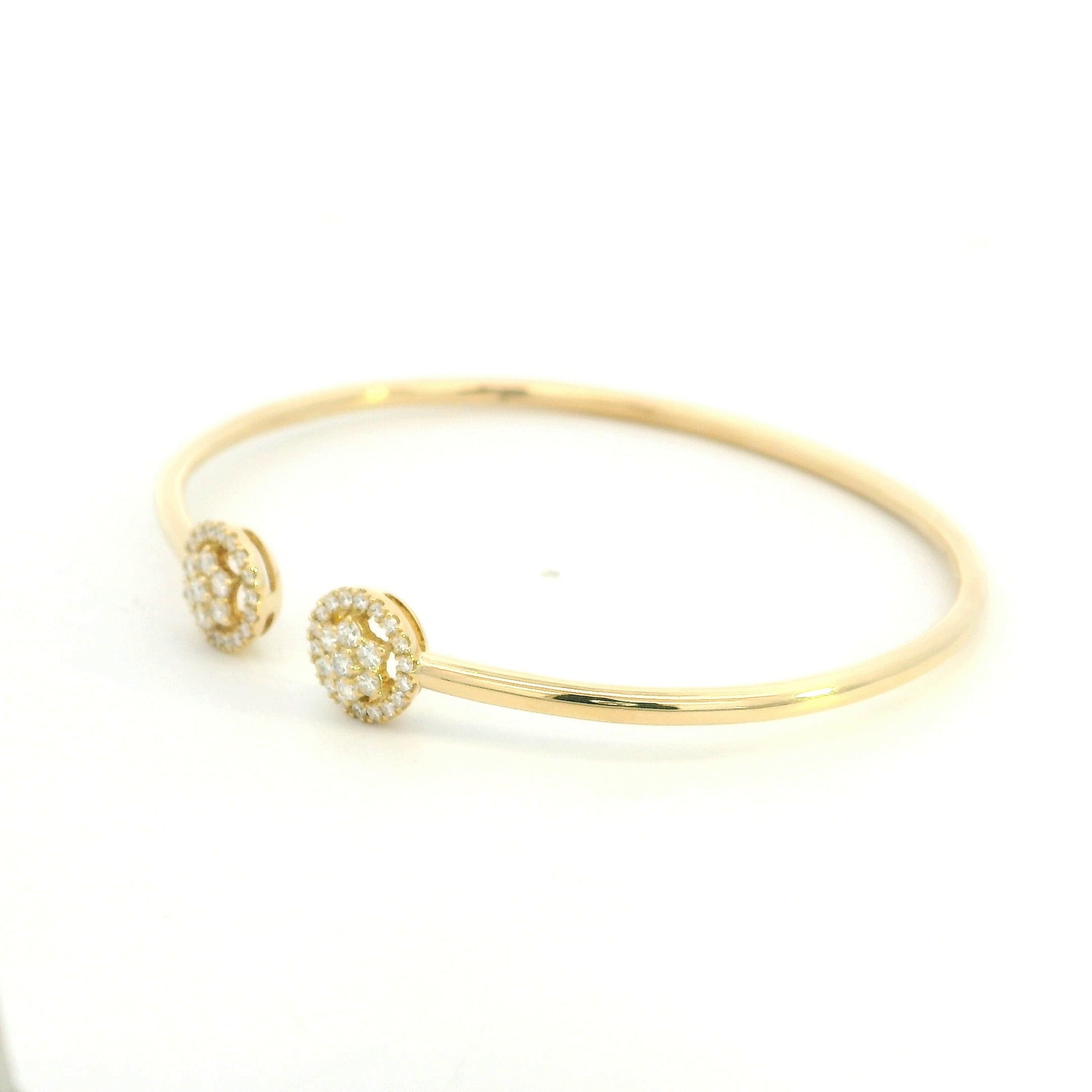 18K yellow gold open cuff bangle with two round natural diamond cluster ends.
