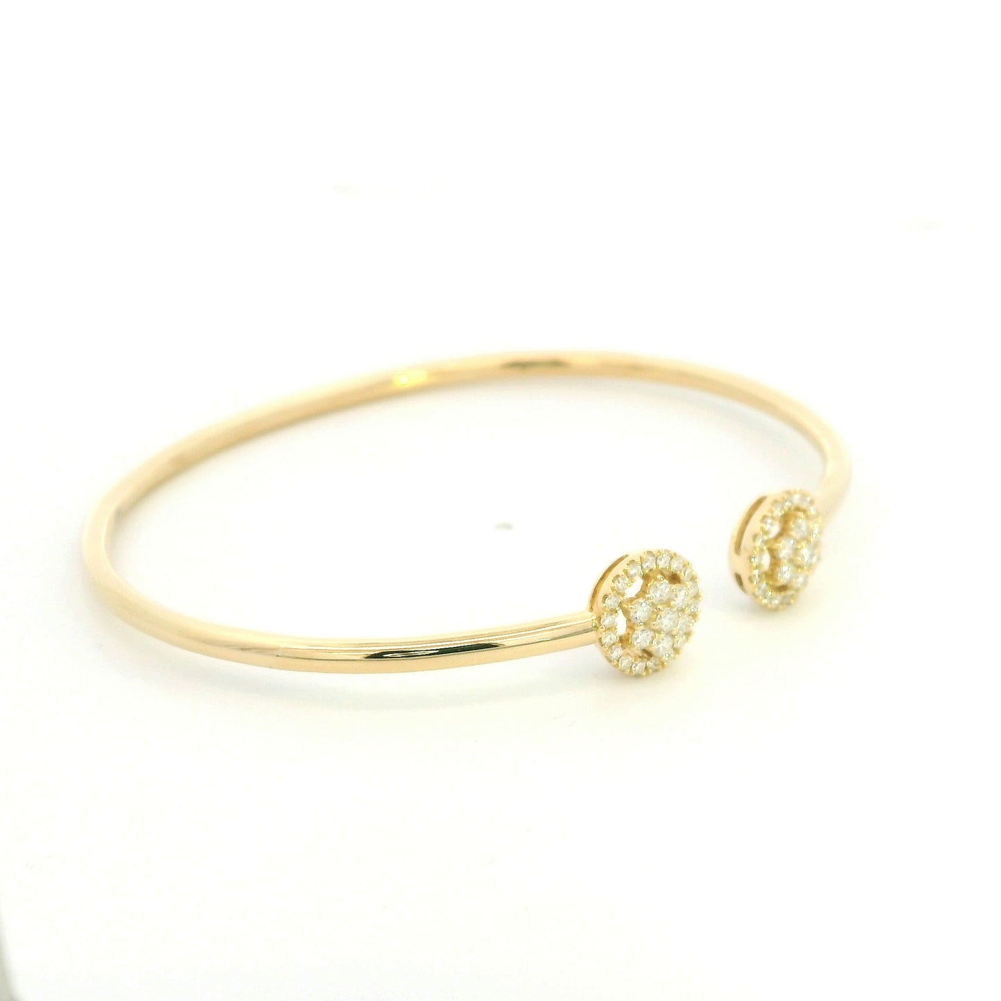 18K yellow gold open cuff bangle with two round natural diamond cluster ends.
