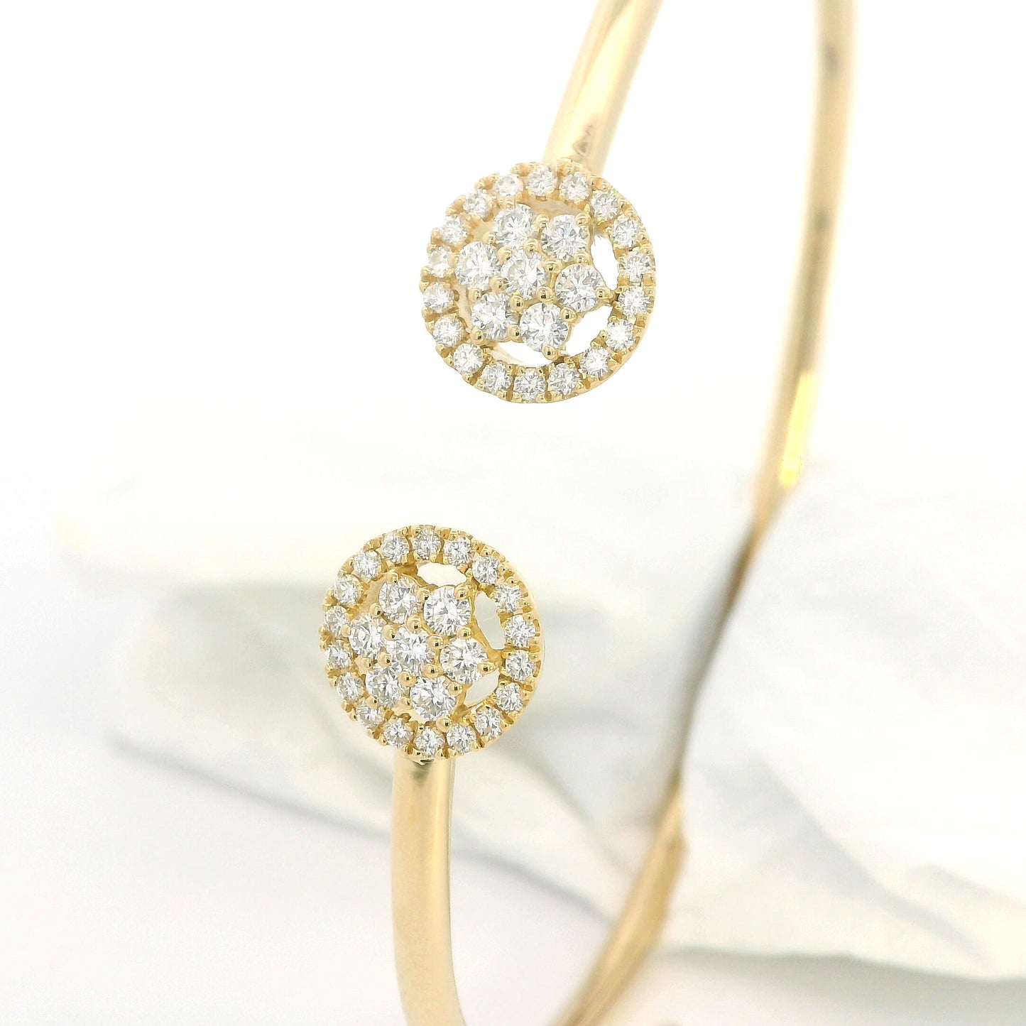 18K yellow gold open cuff bangle with two round natural diamond cluster ends.