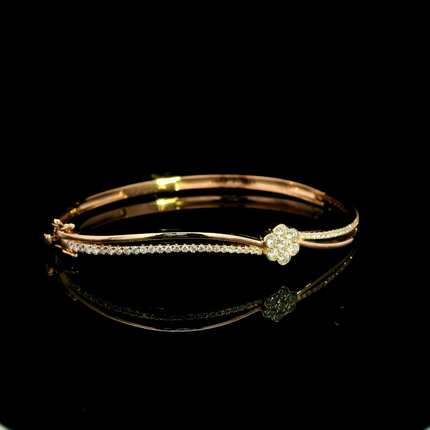 18K rose gold double row diamond bangle with flowing wave design, pavé diamond detailing and central floral diamond motif.