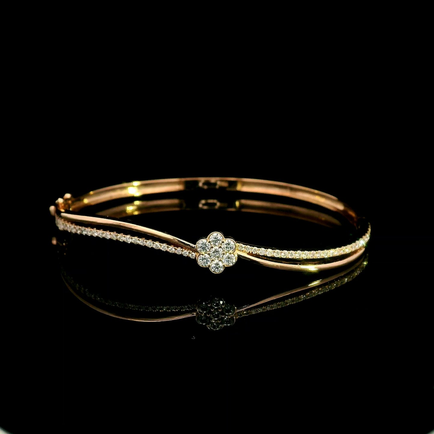 18K rose gold double row diamond bangle with flowing wave design, pavé diamond detailing and central floral diamond motif.