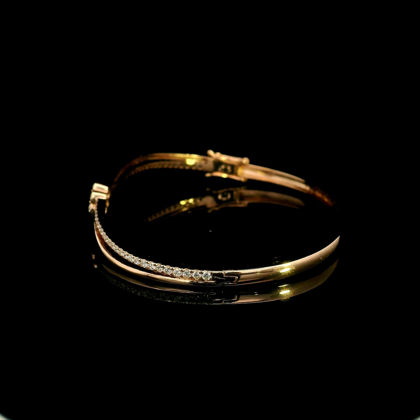 18K rose gold double row diamond bangle with flowing wave design, pavé diamond detailing and central floral diamond motif.