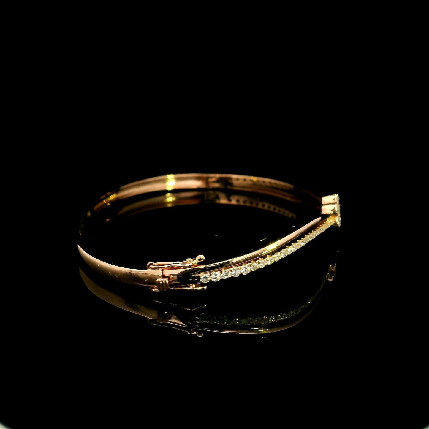 18K rose gold double row diamond bangle with flowing wave design, pavé diamond detailing and central floral diamond motif.