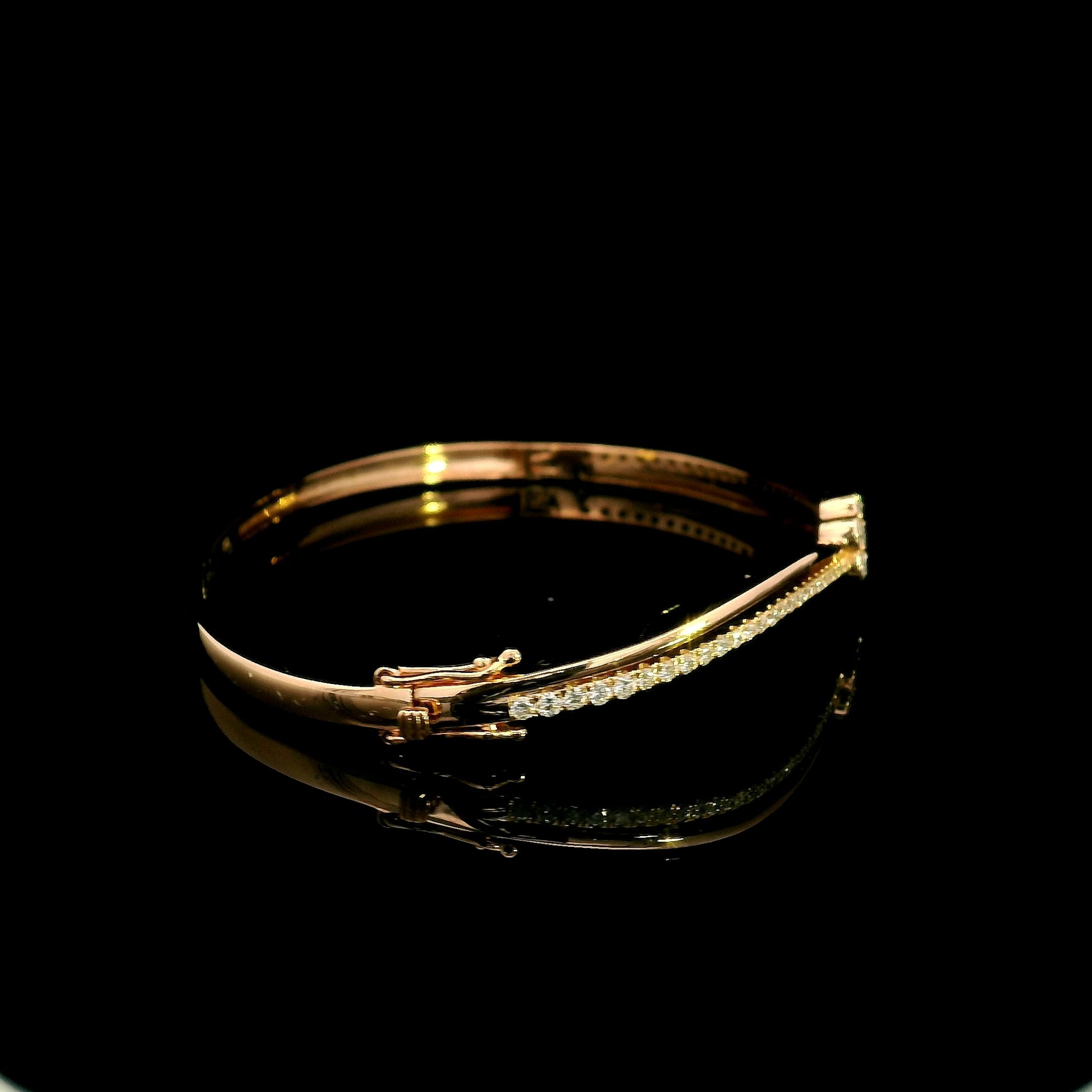 18K rose gold double row diamond bangle with flowing wave design, pavé diamond detailing and central floral diamond motif.
