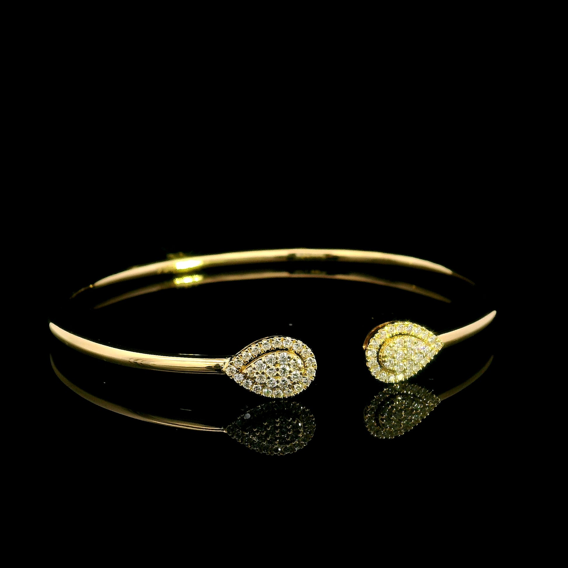 18K yellow gold open diamond bangle with twin pear-shaped diamond cluster ends.