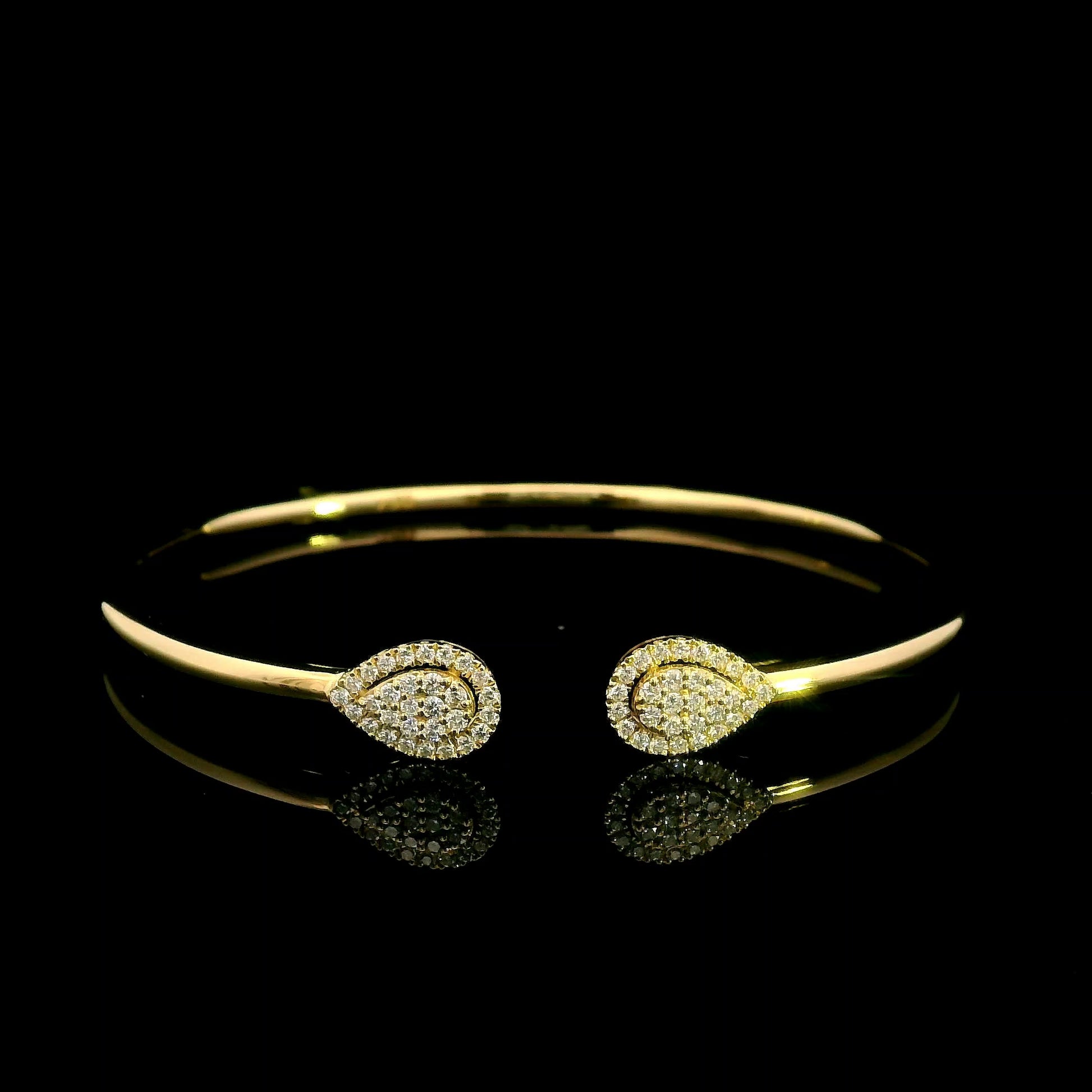18K yellow gold open diamond bangle with twin pear-shaped diamond cluster ends.