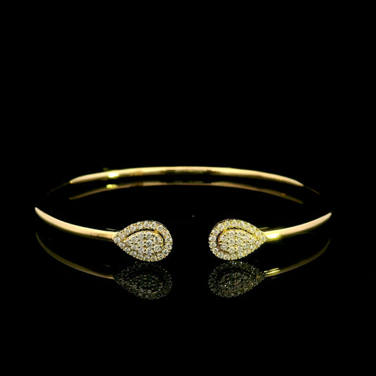18K yellow gold open diamond bangle with twin pear-shaped diamond cluster ends.
