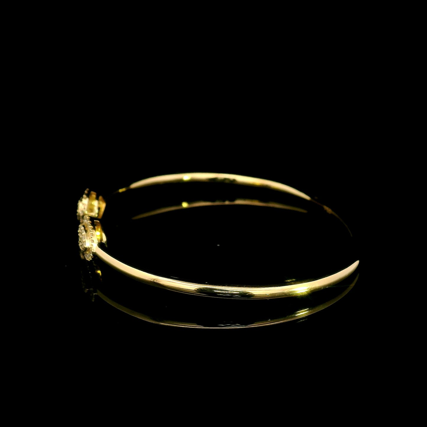 18K yellow gold open diamond bangle with twin pear-shaped diamond cluster ends.