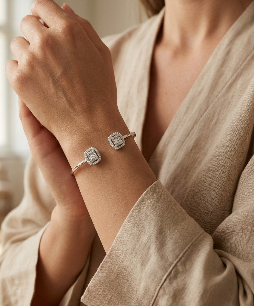 18K white gold open diamond bangle with round brilliant and baguette cut diamonds in matching square geometric ends