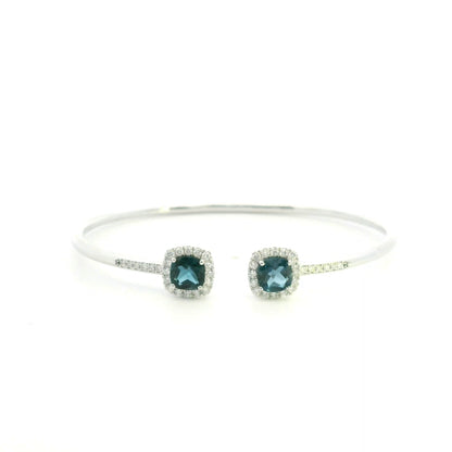 London Blue Topaz and diamond open bangle in 18K white gold with two cushion-cut blue topaz gemstones and diamond surrounds