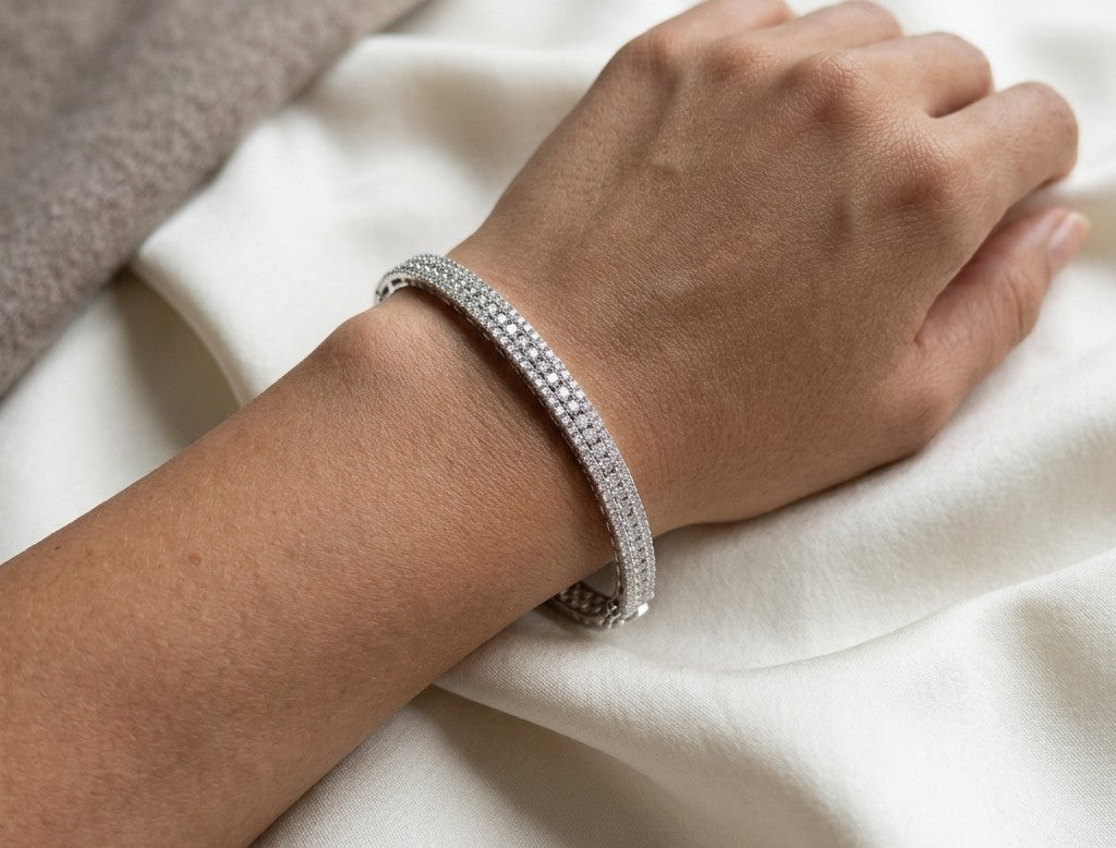 Three row diamond bangle in 18K white gold with parallel rows of round diamonds across the front.