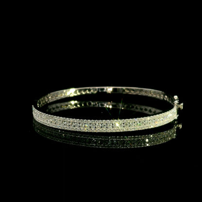 Three row diamond bangle in 18K white gold with parallel rows of round diamonds across the front.