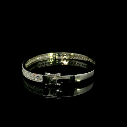 Three row diamond bangle in 18K white gold with parallel rows of round diamonds across the front.