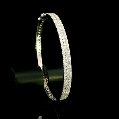 Three row diamond bangle in 18K white gold with parallel rows of round diamonds across the front.