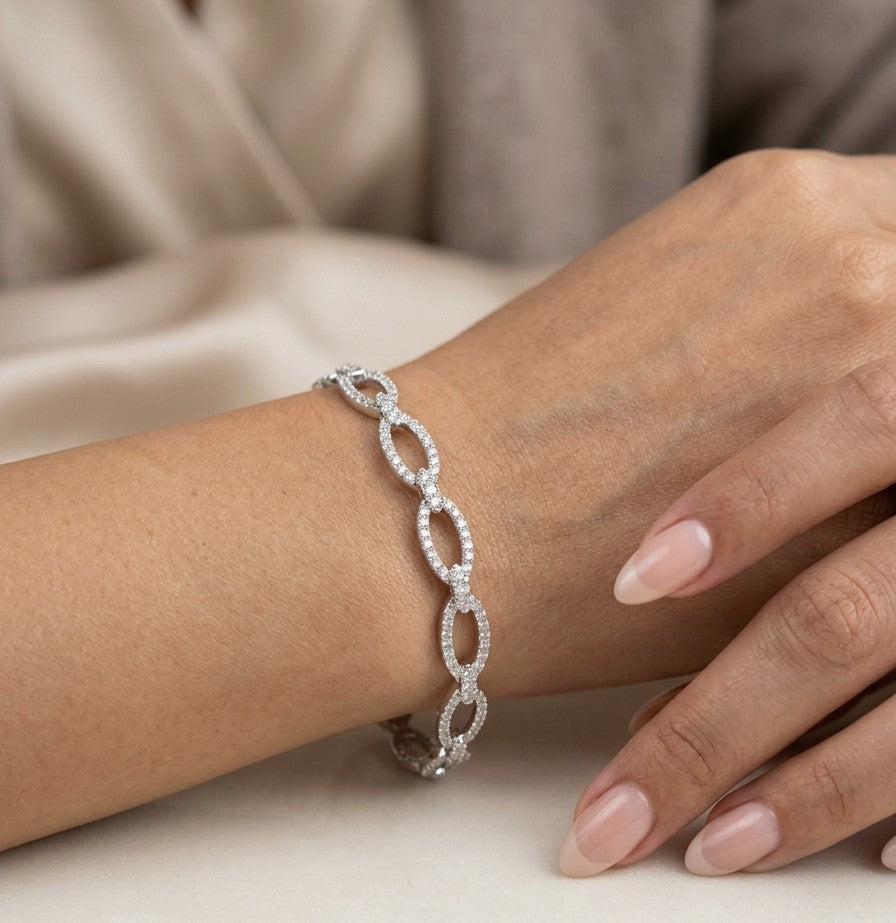 Diamond loop bangle in 18K white gold with repeating diamond-set open loops across the front.
