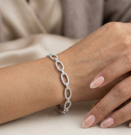 Diamond loop bangle in 18K white gold with repeating diamond-set open loops across the front.