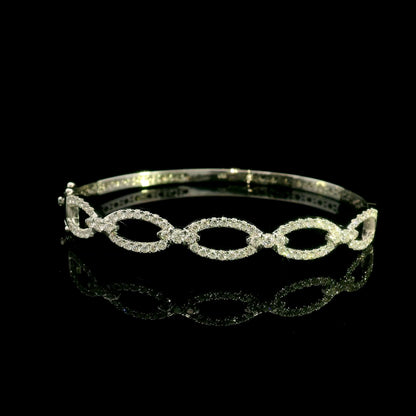 Diamond loop bangle in 18K white gold with repeating diamond-set open loops across the front.
