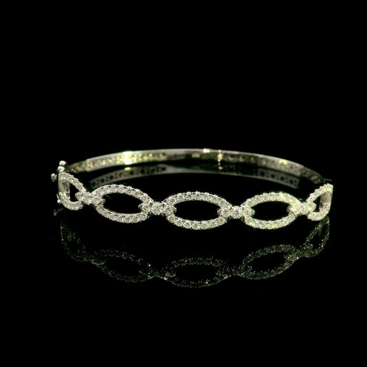 Diamond loop bangle in 18K white gold with repeating diamond-set open loops across the front.