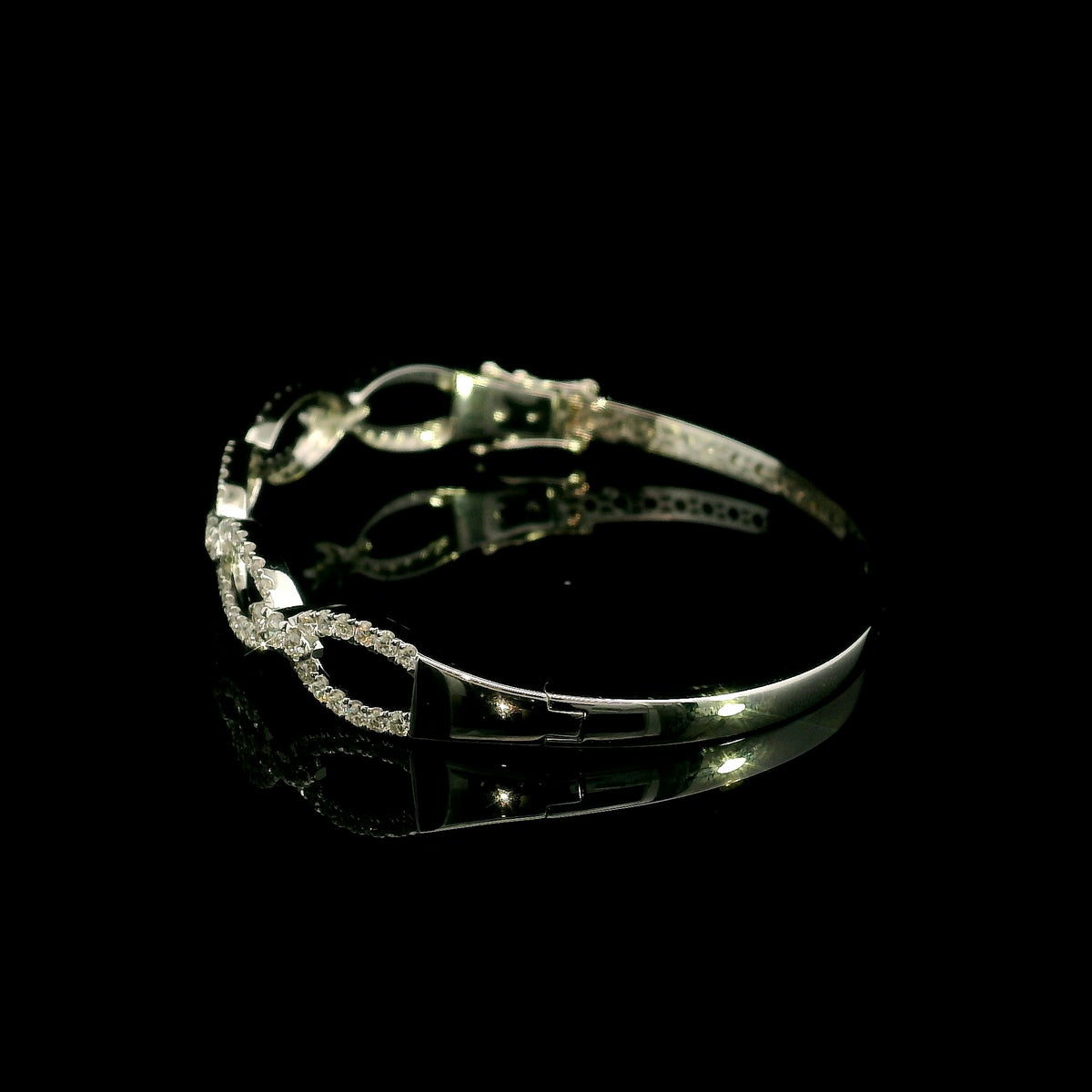 Diamond loop bangle in 18K white gold with repeating diamond-set open loops across the front.