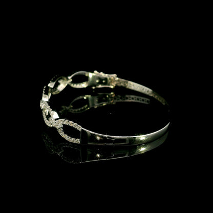Diamond loop bangle in 18K white gold with repeating diamond-set open loops across the front.