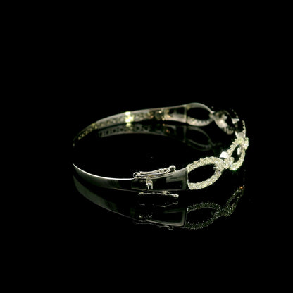 Diamond loop bangle in 18K white gold with repeating diamond-set open loops across the front.