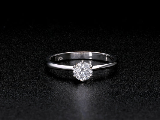 Round brilliant cut diamond solitaire engagement ring in 18K white gold featuring a 0.50 carat natural diamond in a six-prong setting on a slim polished band.