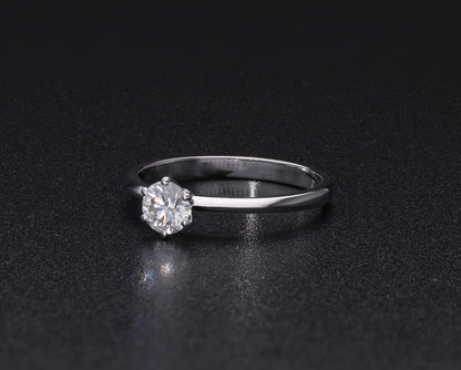 Round brilliant cut diamond solitaire engagement ring in 18K white gold featuring a 0.50 carat natural diamond in a six-prong setting on a slim polished band.