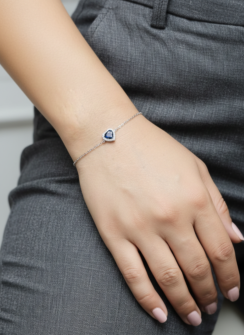 18K white gold heart bracelet featuring a 0.71 carat blue sapphire with diamond halo, total diamond weight 0.11 carat – Emirates Diamonds
