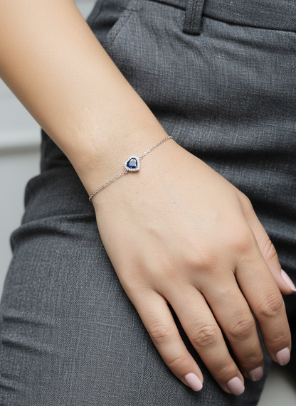 18K white gold heart bracelet featuring a 0.71 carat blue sapphire with diamond halo, total diamond weight 0.11 carat – Emirates Diamonds