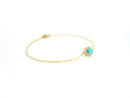 18K gold bracelet with a 0.54-carat turquoise gemstone surrounded by a 0.16-carat diamond halo on a delicate gold chain