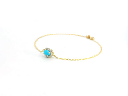 18K gold bracelet with a 0.54-carat turquoise gemstone surrounded by a 0.16-carat diamond halo on a delicate gold chain