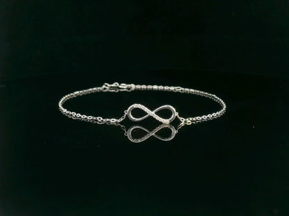 18K white gold infinity bracelet with 0.05 carat diamonds on delicate chain, half polished and half pavé-set