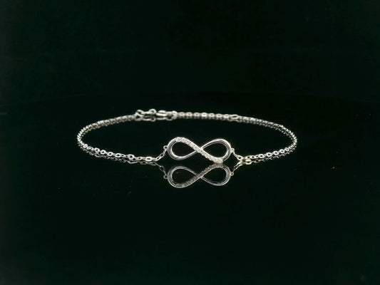 18K white gold infinity bracelet with 0.05 carat diamonds on delicate chain, half polished and half pavé-set
