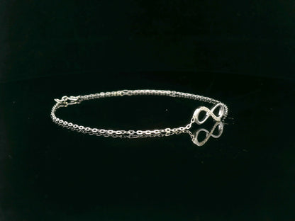 18K white gold infinity bracelet with 0.05 carat diamonds on delicate chain, half polished and half pavé-set