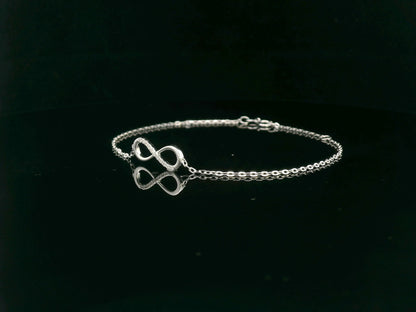 18K white gold infinity bracelet with 0.05 carat diamonds on delicate chain, half polished and half pavé-set
